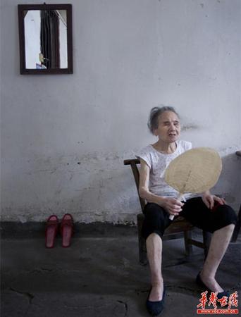 　90歲的王仲蓮如今已患有間歇性的老年癡呆，時而清醒、時而糊涂。圖為王仲蓮老人靜坐在屋內，搖著蒲扇。