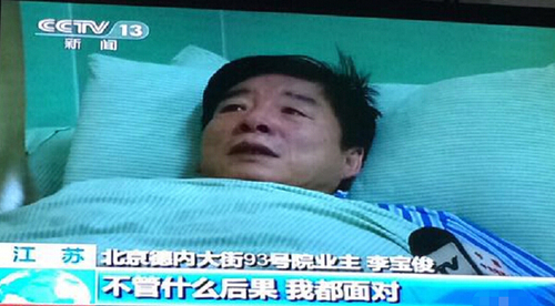 挖坑人大代表躺病床上受訪(fǎng)，流淚稱(chēng)愿受懲罰。視頻截圖