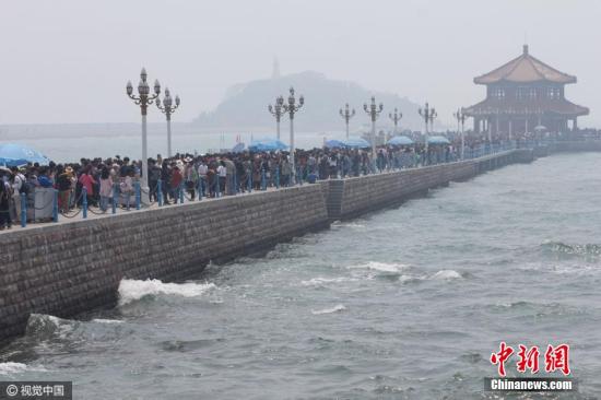 看海還是看人海？4月30日，青島棧橋的小清新氣息全無，只剩下緩慢挪動的各位盡情享受無盡的海風(fēng)。 圖片來源：視覺中國