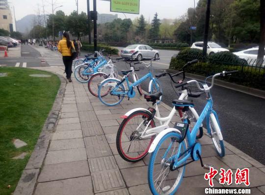 杭州一處人行道上，共享單車無序停放為行人增加了不便?！⊥跻蒿w 攝