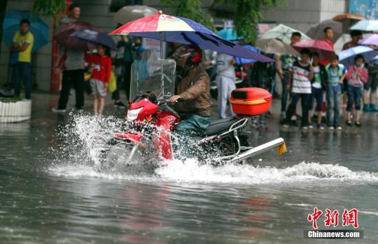 6月12日，貴陽市民騎摩托車在積水路段行駛。<a target='_blank' href='http://www.chinanews.com/'>中新社</a>記者 賀俊怡 攝