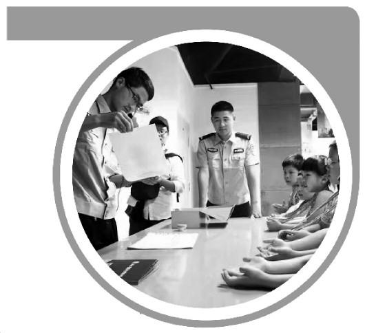 圖2為2017年5月20日“彩虹親子營”活動，湖北警察史博物館講解員劉澤恩（左一）為小朋友們講解指紋按捺。