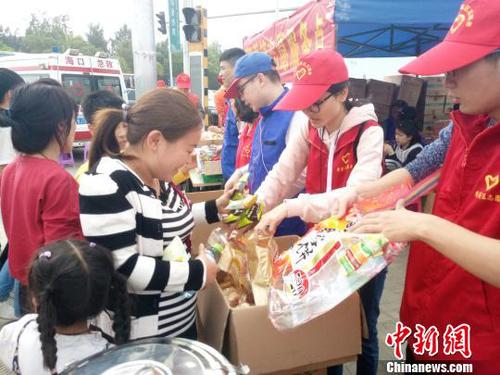 2月21日，海口新海港附近，志愿者為旅客發(fā)放食物?！∫Ｃ?攝